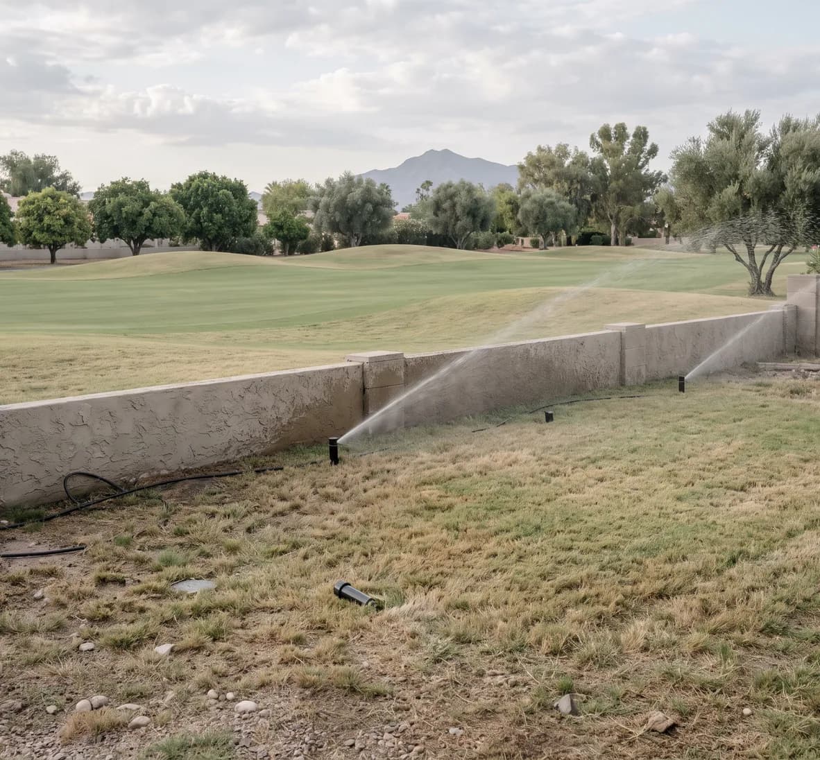 Running station on a back turf strip with one head that never rose and another tilted toward the fairway